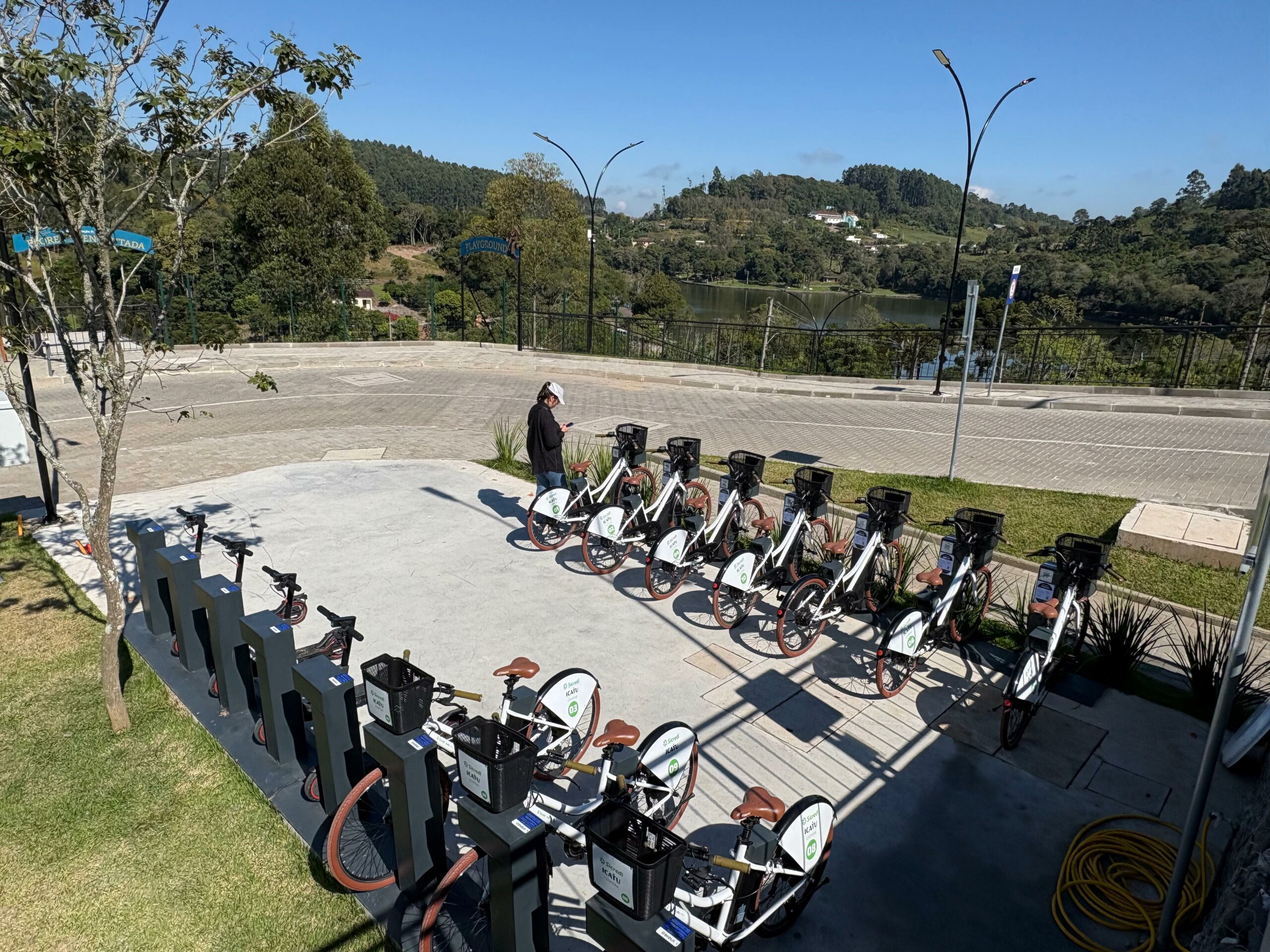 Usuário de bike sharing da Bike Fácil em centro urbano moderno ao amanhecer